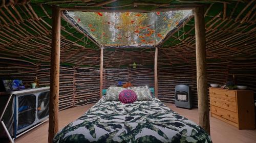 a bedroom with a canopy bed in a room at Selfmade Yurt - NaturViana in Viana do Castelo
