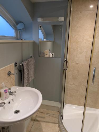a bathroom with a sink and a shower at Snettisham Watermill Pet Friendly Historic Listed Property in Snettisham