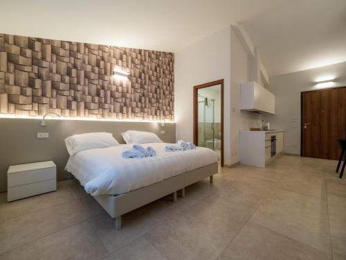 a bedroom with a large bed and a bathroom at Palombarone Resort in Matelica