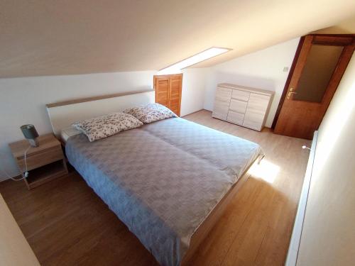 a bedroom with a large bed and a skylight at Apartment Sara in Baška