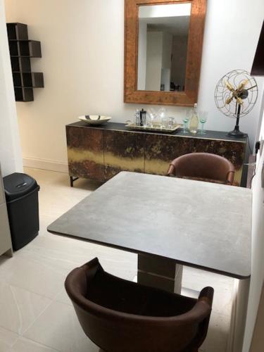 a table and chairs in a room with a mirror at harbourways in Looe