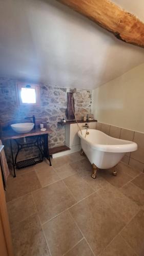 a large bathroom with a tub and a sink at Domaine Saint Claude - Chambres d'hôtes de charme in Malleval