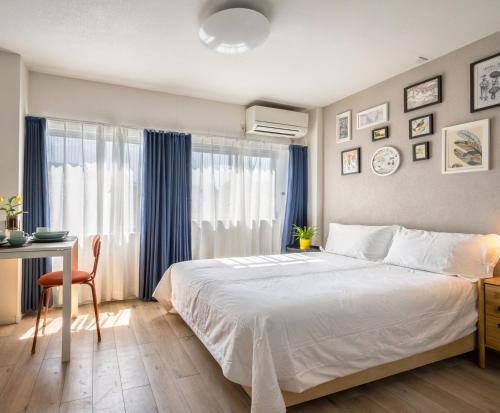 a bedroom with a bed and a desk and a window at Home Story in Tokyo 江戸川区平井駅-上野 秋葉原まで直通 in Tokyo
