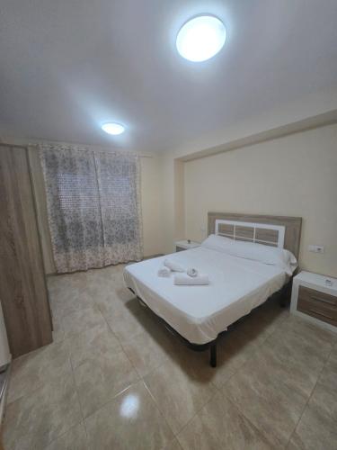 a bedroom with a large white bed in it at Las Jarcias 3A in Moncófar