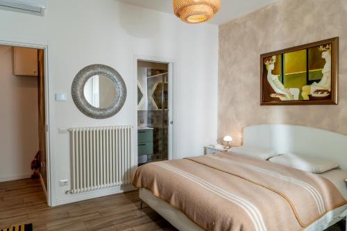 a bedroom with a bed and a mirror at MARCANTONIO ROOM Ampia camera con bagno privato e self check in in Perugia