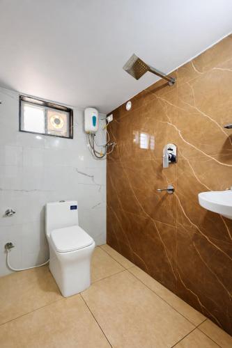 a bathroom with a toilet and a sink at Vizag Urban Nest in Visakhapatnam