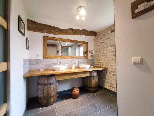 a bathroom with a vanity made out of wine barrels at Omaha Secret Normandy Cottages in Saint-Laurent-sur-Mer