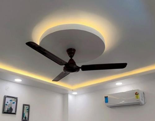 a ceiling fan is on the ceiling of a room at SUNRISE Near Lucknow Airport in Lucknow