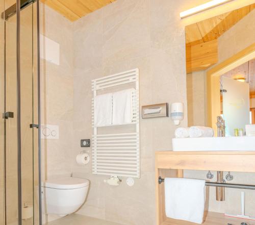 a bathroom with a toilet and a sink at Hotel Langeck in Maria Alm am Steinernen Meer