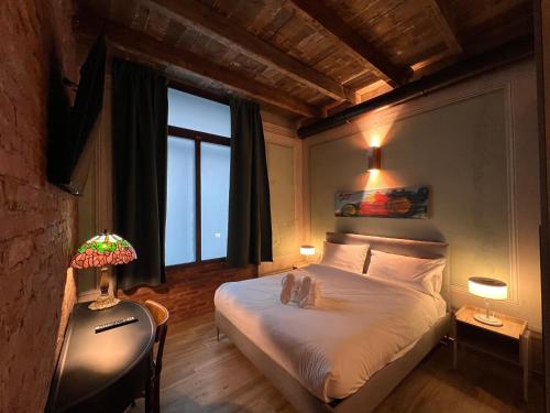 a bedroom with a bed and a large window at Emme Loft I Sweet Moon - Exclusive Loft & Private Spa Milan in Milan