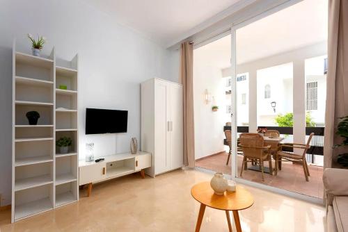 a living room with a television and a table at Fuente de la Duquesa in Manilva