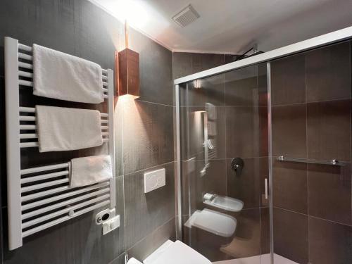 a bathroom with a toilet and a glass shower at Emme Loft I Sweet Moon - Exclusive Loft & Private Spa Milan in Milan