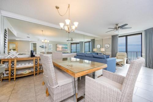 a dining room and living room with a table and chairs at Phoenix X 506 condo in Orange Beach