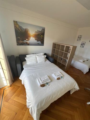 a bedroom with two beds with white sheets at Cosy studio a Lausanne center in Ouchy