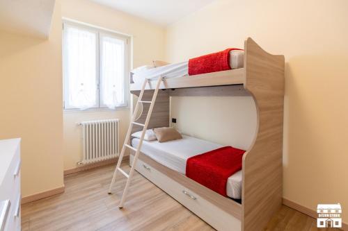 a small bedroom with two bunk beds and a window at CASA MIA by Design Studio in Colico
