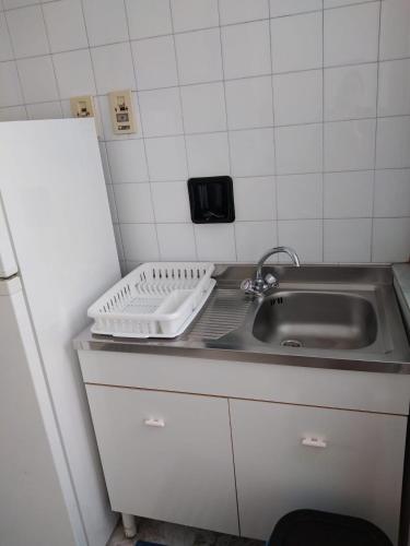 a small kitchen with a sink and a counter top at Casa Abenante in Corigliano Calabro