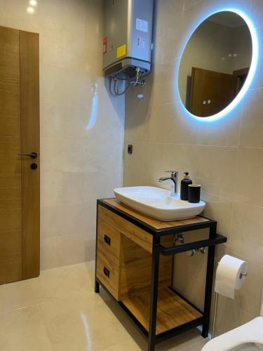 a bathroom with a sink and a mirror at Apartmani PARADISO in Čapljina