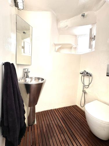 a bathroom with a sink and a toilet at Windmill of Mykonos in Mikonos