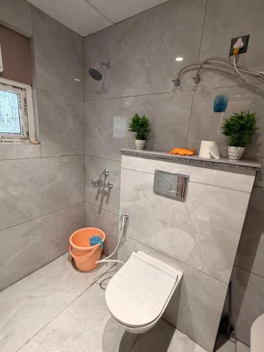 a bathroom with a toilet and a shower at PATEL Residency in Ghaziabad