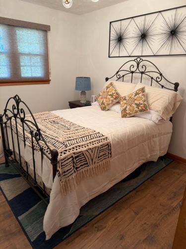 a bedroom with a large bed with a black frame at Diamond Retreat in Sweeden