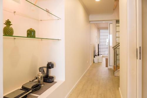 a hallway with a table with a coffee machine on a shelf at South Shore 2 - Jacuzzi - HOST & CHILL in São Roque