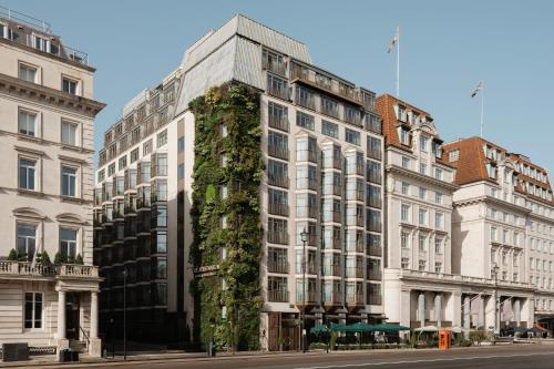 a tall white building with plants on the side of it at The Athenaeum Hotel & Residences in London