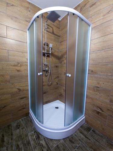 a shower with a glass enclosure in a bathroom at Cabana Z-Haven in Ungureni