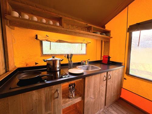 a kitchen with a sink and a counter top at Càmping Parc Gualba in gualba de Dalt