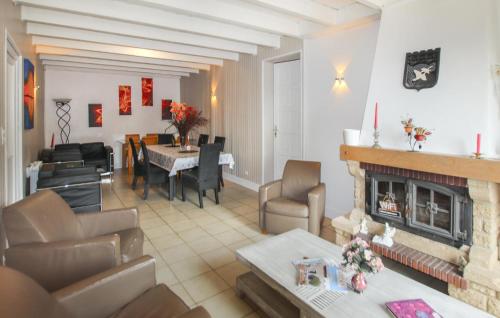 a living room with a fireplace and a dining room at La Terrasse in La Pervenche