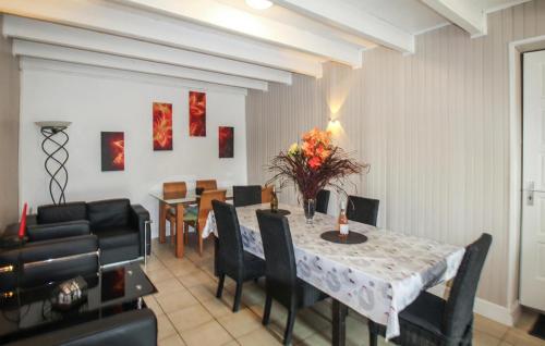 a dining room with a table and chairs at La Terrasse in La Pervenche