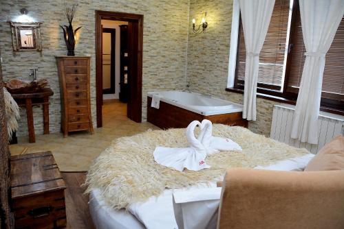 a bathroom with two swans sitting on a pile of hay at Momini Dvori Boutique Guest House in Bansko