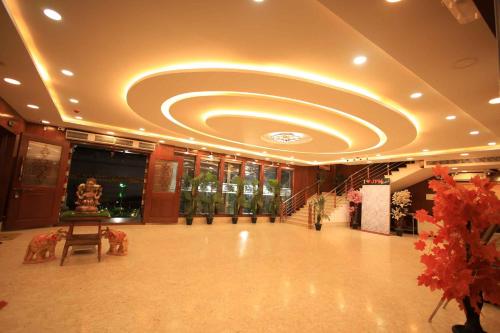 a large lobby with a circular ceiling in a building at Thendral inn in Vellore