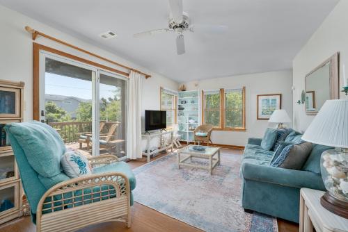 a living room with a couch and a tv at 3660 - Duckingham in Duck