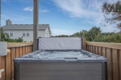 a hot tub sitting on the back of a fence at 3945 - Sea Lodge II in Duck