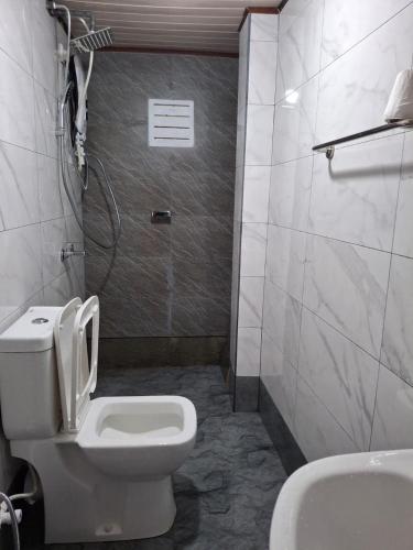 a bathroom with a toilet and a sink at Moon Mist Villa in Kotagala