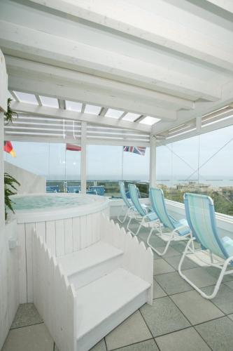 a group of chairs and a pool on a building at Hotel Riz in Cesenatico