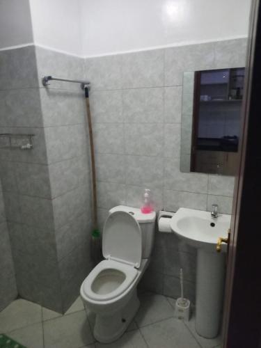 a bathroom with a toilet and a sink at Cavendish Square Studio Unit, Syokimau in Syokimau