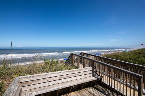 a wooden bench on a boardwalk to the beach at 4205 - Schwartz in Duck