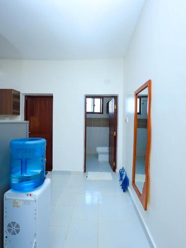 a bathroom with a toilet and a mirror in a room at Ntate Homes, Diani Near the Beach in Diani Beach