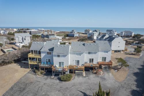 an aerial view of a large house with the ocean at 4208 - Naan Sands in Duck