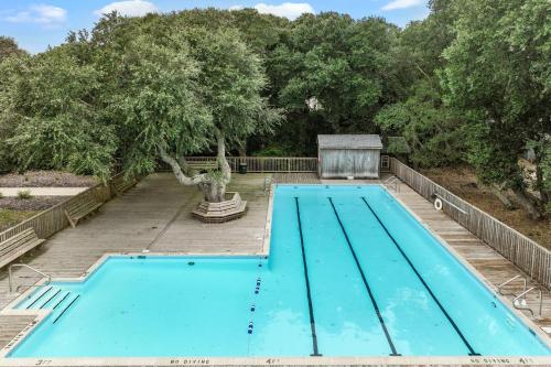 an empty swimming pool with a tree in the background at 4220 - Timeless in Duck