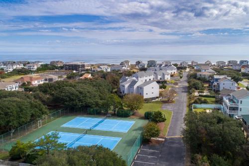 an aerial view of a tennis court and houses at 4220 - Timeless in Duck