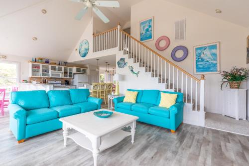 a living room with blue couches and a table at 4751 - Purple Passion in Kitty Hawk Beach