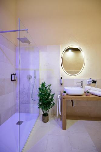 a bathroom with a shower and a sink and a mirror at Mamaco Trani in Trani
