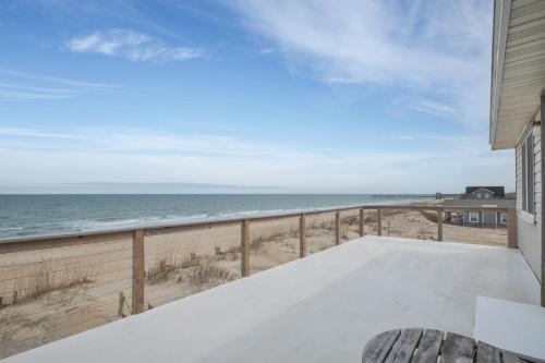 a balcony with a view of the beach at 5061 - Good Night Irene in Kill Devil Hills