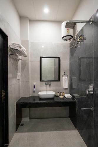 a bathroom with a sink and a shower at The Stripes Ranthambore in Sawāi Mādhopur