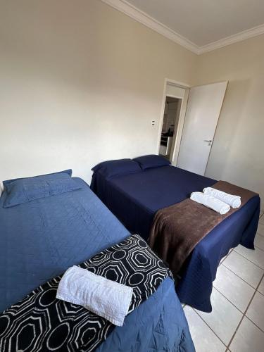a bedroom with two beds with blue sheets at next event patio for 06 people in Petrolina