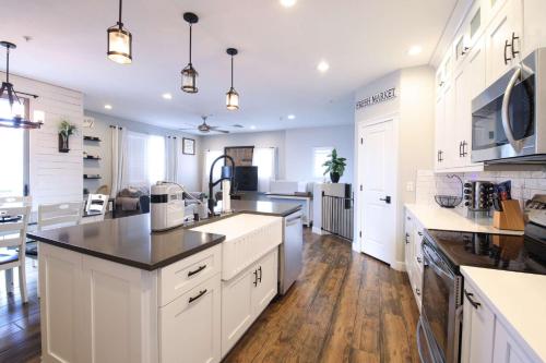 a kitchen with white cabinets and black counter tops at Central Luxury Mountain Oasis with TWO Pools and Jacuzzis in Phoenix