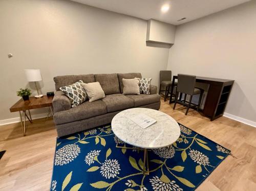 a living room with a couch and a table at Aksarben Modern 1Bed ground level with parking in Omaha