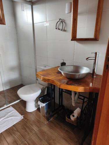 a bathroom with a sink and a toilet at Aconchego da Serra in São Joaquim